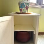 Faux-wood Architectural Forms: A Stylized Medallion Accent Cabinet
